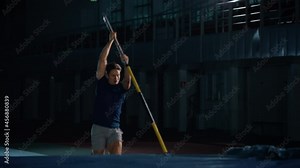 Pole Vault Jump Championship: Professional Male Athlete Running with Pole Successfully Jumping over Bar, Raising Arms, Celebrating. Determination, Motivation of Champion in Training. Slow Motion Shot