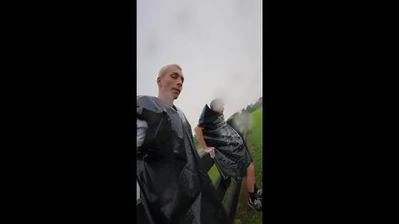 Friends slide down grassy slope with garbage bag in Augusta, Georgia