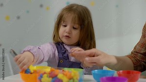 Building Bright Minds: Enriching Visuals of a Girl's Interactive Learning Session with a Teacher, Nurturing Thinking and Logical Abilities. High quality 4k footage