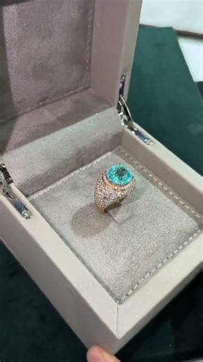 Neon greenish-blue color, accompanied by a Swiss GRS GemResearch Swisslab