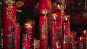 Burning candles in buddhist temple. Chinese burn incense with candle lights in the temple to pay homage. Shengyixinglong: thriving prosperous business. Zhaocai jinbao: let riches come into the house.