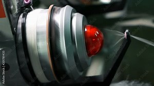 Сlose-up of the spool process fabric creation on a modern weaving loom in a factory