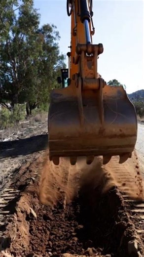 Powerful BACKHOE digging a PERFECT TRENCH for road work! 🚧 #HeavyMachinery #Construction #Shorts