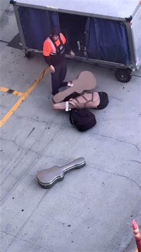 Baggage handler sparks outrage for tossing guitar on tarmac #shorts