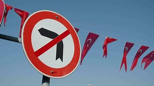 Download No Left Turn Sign traffic sign against blue sky for free