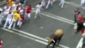 People run from raging bull along streets