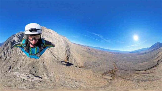 Man dives into a wingsuit terrain skydive in the Eastern Sierra.