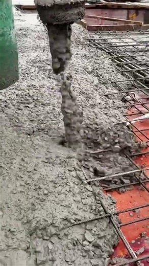 Pouring Fresh Concrete Over Steel Reinforcement for a Strong and Solid Construction Foundation