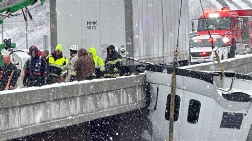 Tractor-trailer driver rescued from dangling cab on West Virginia bridge