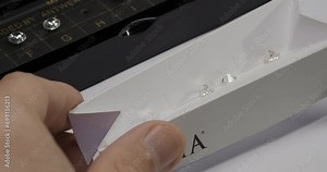 Specialist checks diamond quality. Diamond color grading with master stones. Gemstone laboratory. Diamond or gem grading and valuation. Close-up