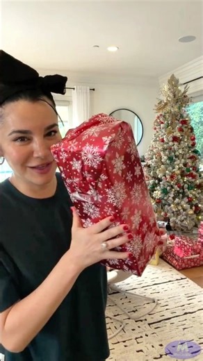 Martha Higareda and Lewis Howes open their Christmas presents