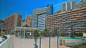 Beautiful new modern residential area in Monaco. Skyscrapers buildings with beach views, tall glass window luxury houses in Monaco, French Riviera.