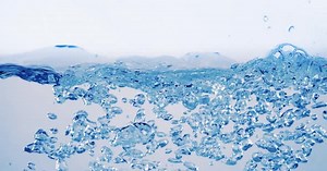 Many bubbles in water close up, abstract water wave with bubbles in slow motion