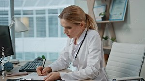Consulting doctor taking notes during medical examination. Closeup pregnant