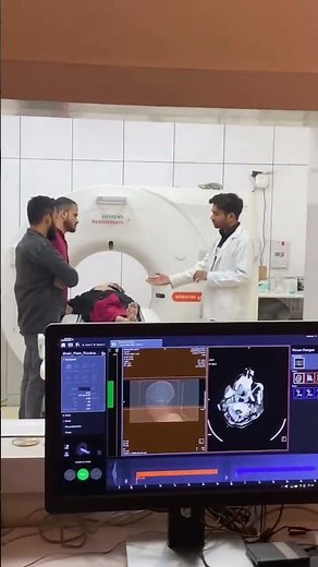 Dr Noorul Hasan meticulously reviewing CT scan results to ensure the most accurate diagnosis