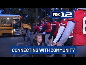 Oregon City HS football team starts Fridays with elementary school visits