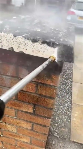 Exterior Maintenance High Pressure Washing of a Stone Pillar and Brick Wall