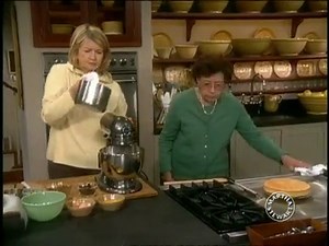 White cake is layered with a fruit and nut filling and slathered with fluffy frosting in this traditional Southern dessert. http://bit.ly/3eyXUoE | Martha Stewart