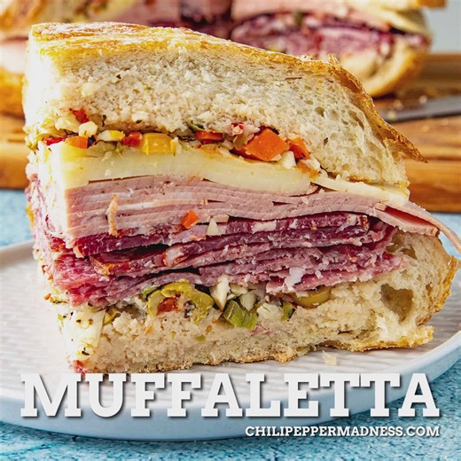 This muffaletta recipe is the ultimate sandwich from New Orleans, piled high with Italian meats, cheese, and a homemade spicy olive tapenade. Feeds a crowd! 🙃 GET THE RECIPE: https://www.chilipeppermadness.com/recipes/muffaletta/ | Chili Pepper Madness - Big Flavor Recipes