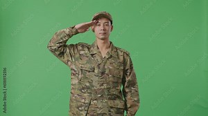 Asian Man Soldier Saluting While Standing In The Green Screen Background Studio