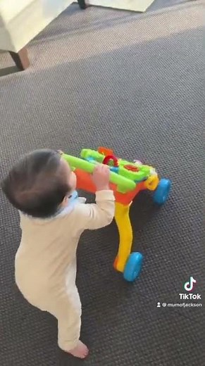 Baby walking with Vtech push walker