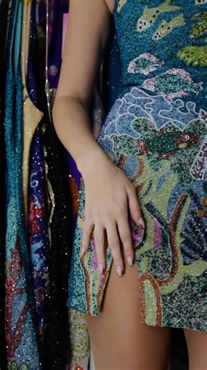 Oceanus on Instagram: "This sea life-inspired dress evokes the vibrant underwater world of the Persian Gulf. The dress is adorned with shimmering glass beading, intricately designed to resemble corals, shells, and marine life. The rich hues of deep coral, aquamarine, soft peach, and emerald green evoke the colors of the sea, while delicate beadwork adds texture and dimension, mimicking the intricate patterns found in marine ecosystems."