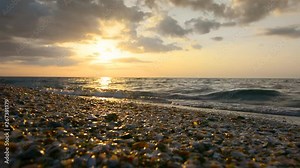 Beautiful sunset at ocean beach - nature waves on shells and sand backgrounds