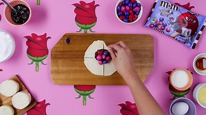 This Valentine's Day create an elegant treat by shaping sweet buns into delicate roses filled with raspberry jam and Triple Chocolate M&M’s. Full recipe below! #valentinesday . . Prep Time: 20 minutes Cook Time: 20 minutes Total Time: 40 minutes Makes: 10 Ingredients: 1 pkg (7.5 oz) refrigerated biscuit dough 3/4 cup seedless raspberry jam 1 cup Triple Chocolate M&M’s, divided 1 egg, lightly beaten 1 cup confectioner’s sugar 2 tbsp milk (approx.) 1/2 tsp vanilla extract Instructions: Preheat ove