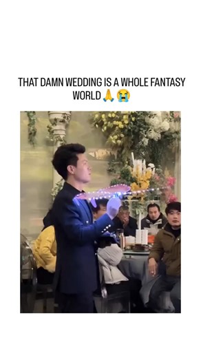 @joy_trend_01 on Instagram: "The video depicts an extravagant East Asian wedding venue adorned with lush floral arches, glowing crystal chandeliers, and projected butterflies under purple-blue lighting, creating an immersive fairy-tale ambiance for the bride in a flowing white gown and groom in tuxedo. Shared by @PicturesFoIder , a curator of viral global media, the post exploded to 80,000 likes and 1.5 million views in under 24 hours, amplifying trends in high-budget weddings that blend technol