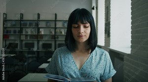 Contemplative woman reading in a library. Close-up with ambient lighting. Education and thoughtfulness concept. Design for book cover, banner. Close-up shot with soft focus background.