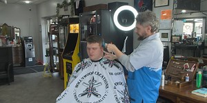 Clarksburg barber offers free haircuts each month for different service professions