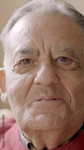 Old man smiling at camera sitting in a nursing home