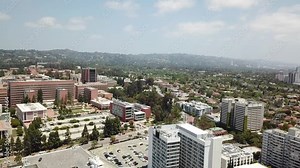 Los Angeles, California Aerial View with the Hollywood Hills and Beverly Hills in the Background on a Warm Sunny Day. Westwood and Willshire Boulevard.