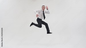 Breakdancer shows movements in break dance, jump spreading his legs, in office clothes with a tie on a white background. Adult male break dancer dancing while looking at the camera
