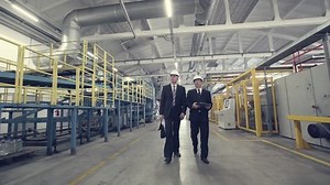 Two businessmen walking through factory