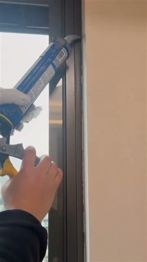 Applying sealant to window frame using caulking gun carefully #construction #popular