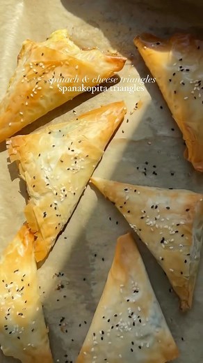 Iram Mansoor on Instagram: "Spinach & cheese triangles recipe Ingredient Phyllo pastry sheets 1 cup baby spinach 1/2 cup mozzarella cheese 1/2 cup feta cheese 1/3 tsp salt ( or add salt accordingly because feta and mozzarella is already salty) 1 tbsp pepper 1 tbsp red chili flakes 3 tbsp unsalted butter 1 egg 1 onion (diced) Sesame seeds for garnish Method Preheat oven at 400 F. In a pan heat some oil and sauté onion and spinach . In a bowl add the sautéed onions and spinach. Add feta, mozzarell