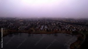 aerial of vernon hills residential houses located next to century park sledding hill at blue hour - twilight sorounded by mist