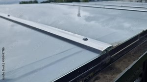 brown glued wooden structure of the pergola supported by smooth cylindrical white columns shelter of a gazebo pergola. the roof is made of slats and glass panes, tree top, kvh, maple bare tree Stock Video