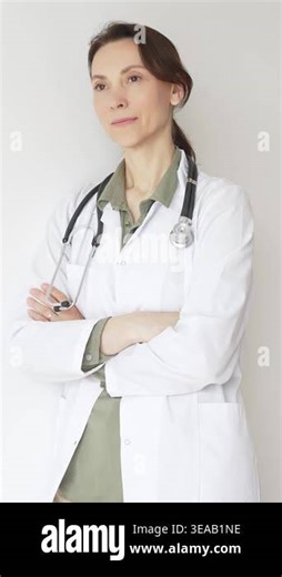 Female medical professional wearing a lab coat and stethoscope stands confidently with her arms crossed, exuding professionalism and expertise in healthcare. Medicine and health care Stock Video Footage - Alamy