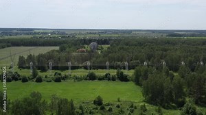 Radio Telescope, Pushchino Radi Shooting from a quadrocopter, flying over a system of radio telescopes. Bright sunny weather. Metal poles with antennas and a large radio telescope are clearly visible.