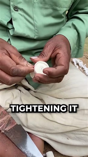a man making flower using a stump