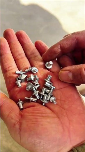 Hand steadies metal frame—screws tighten grip as handle locks firm against concrete floor