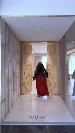 MOSH ARCHITECTS on Instagram: "The first thing that catches your eye as you step in is the main door - a bold yet balanced piece where brass inlays cut through wood in uneven, organic shapes, brought to life with CNC precision. It’s not just an entry, it’s the beginning of the home’s story - warm, detailed, and quietly luxurious. Walk inside, and the drawing room continues that same thought. A cozy corner with a soft-toned sofa, an accent chair, and a center table that instantly sparks curiosity