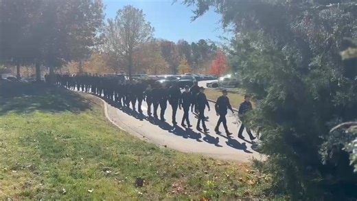 Officers line up for a funeral procession for 59-year-old WakeMed officer Roger Smith. | WRAL TV