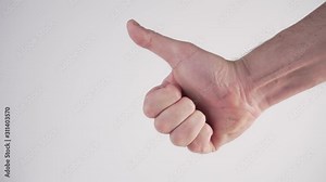 A young man puts his fingers together and shows a LIKE sign in his hand on a white background. International sign language. The impact of social networks