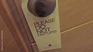 hanging card, do not disturb information on door handle in hotel room