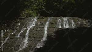 Aerial view of mountain forest waterfall. Water breaks from the rocks and falls down. Shots in slow motion of the waterfall. Slow motion shot of falling water from the waterfall Stock Video