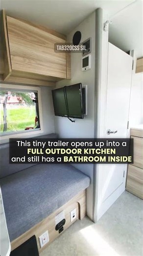 This tiny trailer opens up with a full kitchen and still has an indoor bathroom.