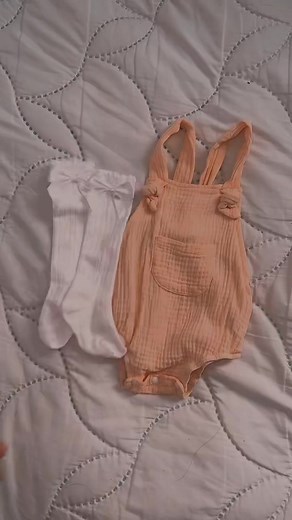 Adorable Baby in Peach Outfit Engaging with Plush Toy